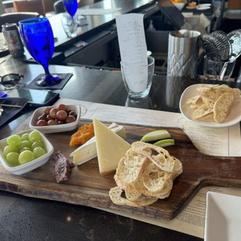 Eno Vino Wine Bar And Bistro signature dishes Various cheese and charcuterie boards, Ahi Tuna Crisps, Truffle Fries, seasonal flatbreads and small plates designed for sharing, steak and seafood entrees.